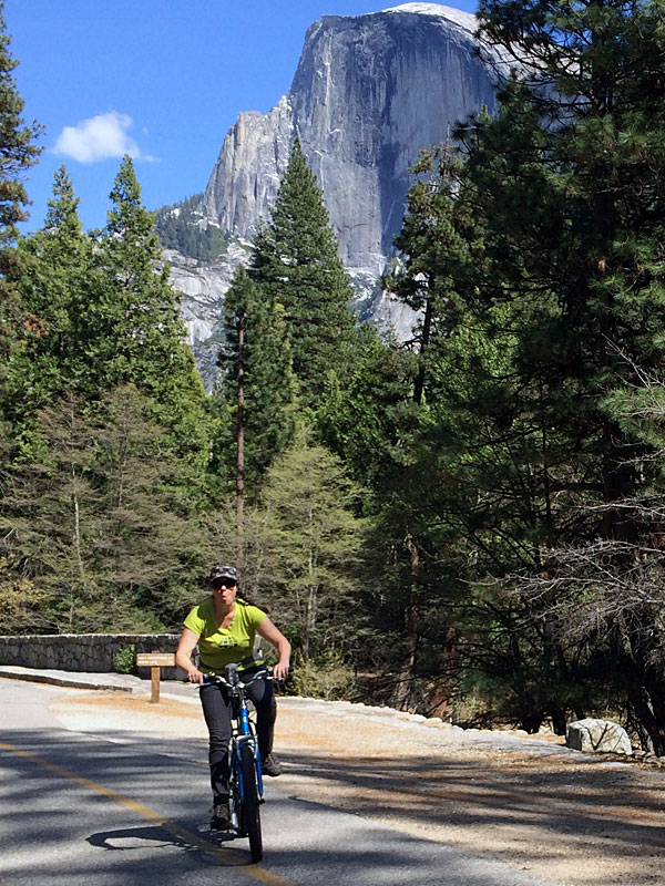 Kim goofs around while biking below Half Dome