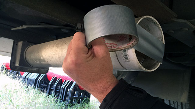 Patching the sewer pipe storage tube with duct tape.