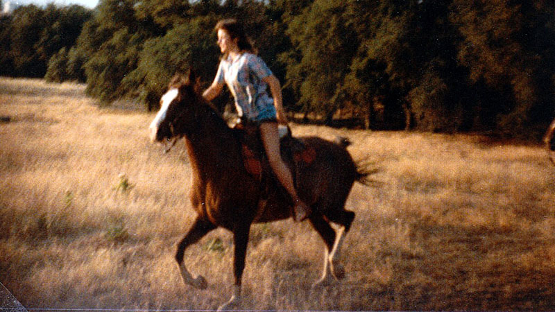 Kim, riding a horse across the California countryside